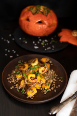 Baked Halloween pumpkin stuffed with lentil salad