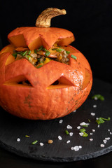 Baked Halloween pumpkin stuffed with lentil salad