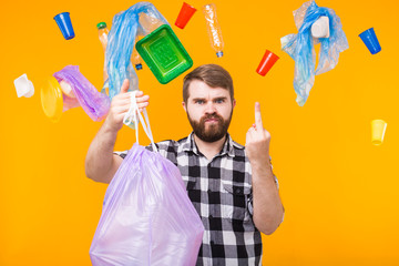 Problem of trash, plastic recycling, pollution and environmental concept - angry man holding...