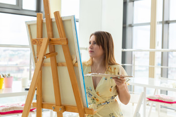 painting art classes. drawing courses. skills imagination and inspiration. Charming student girl creating picture on easel.