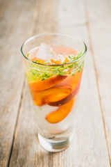 Gin based cocktail with peaches and thyme. Selective focus. Shallow depth of field.