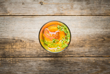 Gin based cocktail with peaches and thyme. Selective focus. Shallow depth of field.