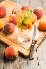 Gin based cocktail with peaches and thyme. Selective focus. Shallow depth of field.
