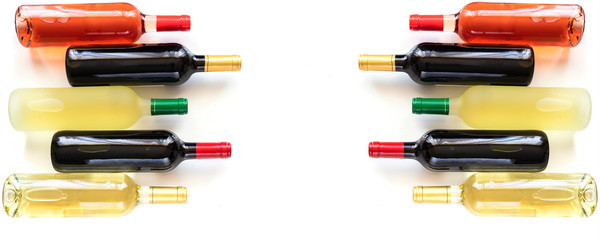 Fototapeta premium Bottles of different wines red, white, rose and Bordeaux on large background for banner.