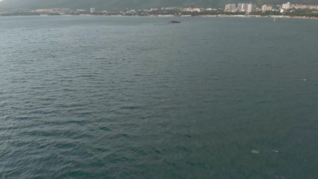 High-altitude two-masted high-altitude vessel near the coast of the sea. Aerial shot