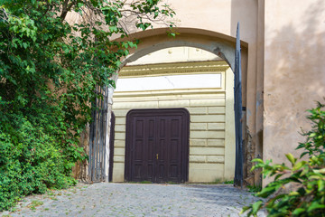 Open steel gate with access to a small street