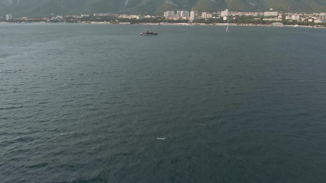 High-altitude two-masted high-altitude vessel near the coast of the sea. Aerial shot