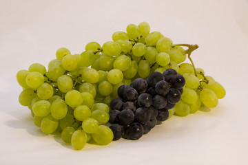 clusters of grapes on a white background, clusters of white and black grapes