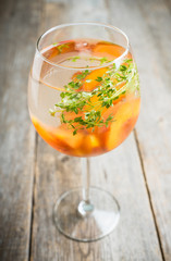 Gin based cocktail with peaches and thyme. Selective focus. Shallow depth of field.