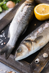 Fresh branzino fish with parsley, lemon and pink Himalayan salt