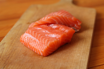 Raw Salmon Fillet on cutting board (soft focus)