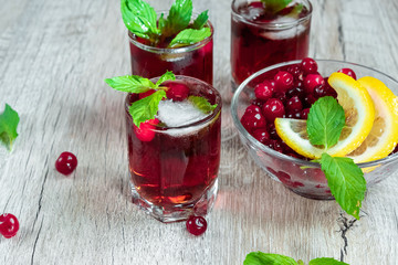 Red stemware shot alcoholic cold cocktail with cranberries raspberries lemon and mint. Selective focus, copy space.