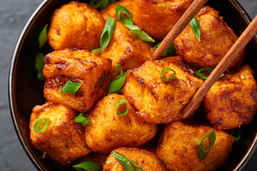 Paneer Manchurian or Paneer 65. Paneer Manchurian is Indian Chinese cuisine dish with panner cheese, tomatoes, onion, soy sauce. Close Up