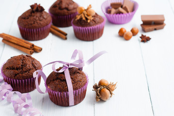 chocolate muffins with hazelnuts on white wooden