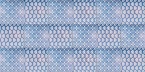 Vintage blue and white ceramic tiles wall pattern design background or square abstract for interior room. Texture of old house wallpaper in art style. Web page concept. Cement tile floor.