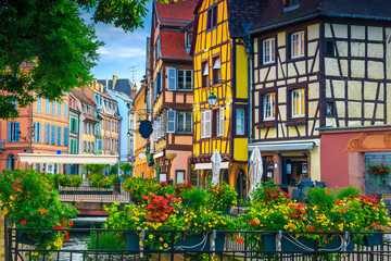 Beautiful antique half-timbered facades with decorated street, Colmar, France