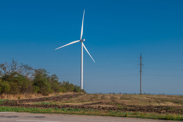 Wind power stations work in the field.