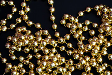 Golden christmas decoration on a dark surface close up. Abstract background