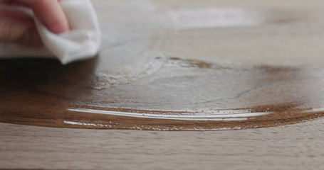 woodworker applying oil finish to black walnut board