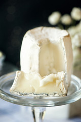 Traditional French goat milk cheese Saint-Maure-de-Touraine on a piece of delicate farm bread . Russian farm products. Close up. Selective focus.