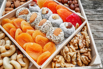 Dried fruit platters for Ramadan in wooden boxes. Background of Oriental sweets for the holiday. Variety of sweet food