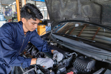 People are repair a car Use a wrench and a screwdriver to work.Safe and confident in driving. Regular inspection of used cars. It is very well done.