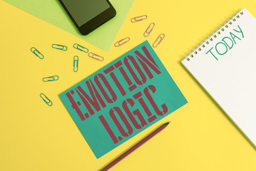 Word writing text Emotion Logic. Business photo showcasing Heart or Brain Soul or Intelligence Confusion Equal Balance Blank spiral notepad pencil clips smartphone paper sheets color background
