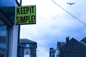 Writing note showing Keep It Simple. Business concept for ask something easy understand not go into too much detail Green ad board on the street with copy space for advertisement