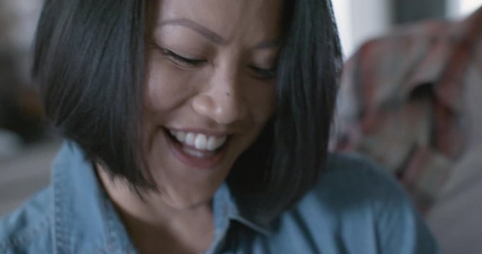 Close up of beautiful trendy Asian American woman smiling confidently laughing and talking in her home. Care love tenderness with bright soft sunlight. Medium shot on 4K.