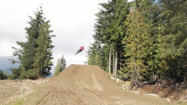 downhill biker jumping no hands slow motion