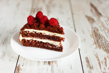 A slice of red velvet chocolate cake on white plate.