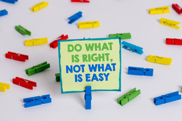 Conceptual hand writing showing Do What Is Right Not What Is Easy. Concept meaning willing to stand up for what is right Colored clothespin papers empty reminder white floor office