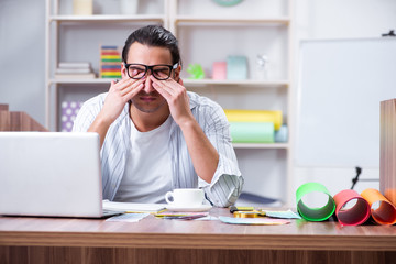 Young male designer working in the office