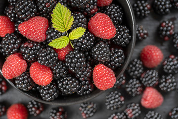 Background from fresh organic blackberries and raspberries, close up. Top view blackberry and raspberry