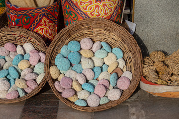 Colorful pumice stones in the wicker basket on the street market. Sharm el Sheikh, Egypt