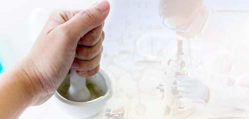 The doctor is crushing the medicine in laboratory
