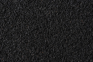 Black cumin texture. Background with copyspace. Close up. Top view