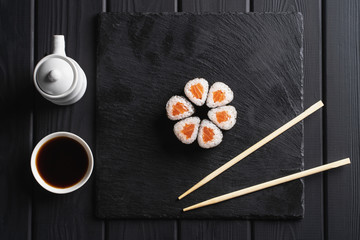 Delicious sushi, maki, nigiri pieces on black background