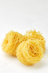 raw pasta capellini isolated on white background