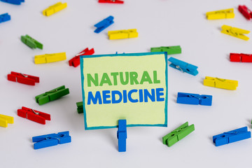 Conceptual hand writing showing Natural Medicine. Concept meaning any of various systems of healing or treating disease Colored clothespin papers empty reminder white floor office