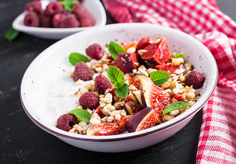 Chia seed pudding made with raspberries,  figs and mint on dark background.  The concept of good nutrition.