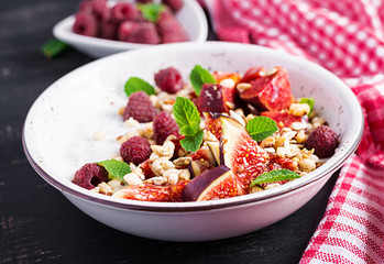 Chia seed pudding made with raspberries,  figs and mint on dark background.  The concept of good nutrition.