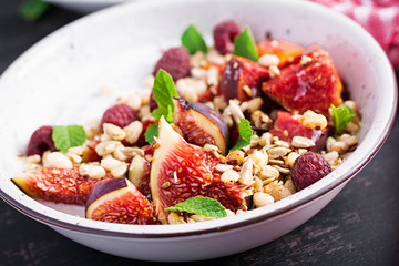 Chia seed pudding made with raspberries,  figs and mint on dark background.  The concept of good nutrition.