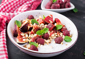Chia seed pudding made with raspberries,  figs and mint on dark background.  The concept of good nutrition.