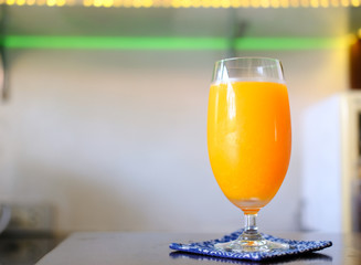 glass of orange juice on wooden table