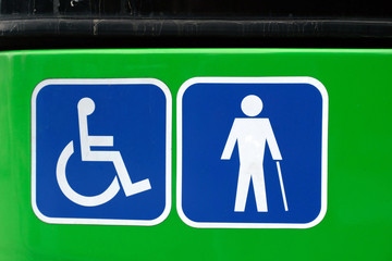 two signs informing the public bus is suitable for people in wheelchairs and provides accessibility...