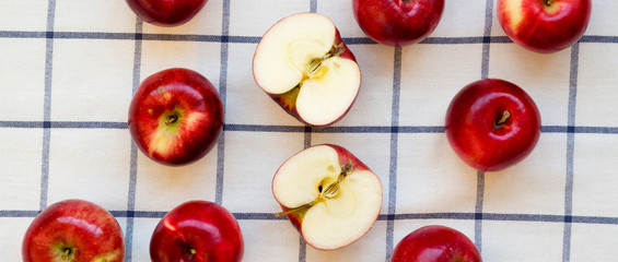 Raw red apples on cloth, top view. Flat lay, from above, overhead. Closeup.