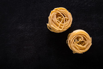 Italian pasta on a black isolated background close-up.