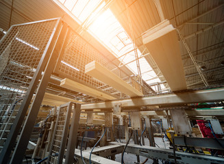 Production line of the wooden floor factory. CNC automatic woodworking machine.