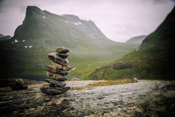 A cairn of stones on a background of mountains, an amazing landscape in the mountains of Norway, a...